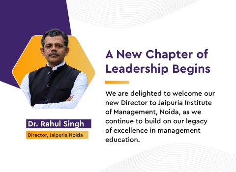 Banner announcing a new leadership chapter with a man in a dark vest; headline 'A New Chapter of Leadership Begins' and text welcoming the new Director of Jaipuria Institute of Management, Noida.