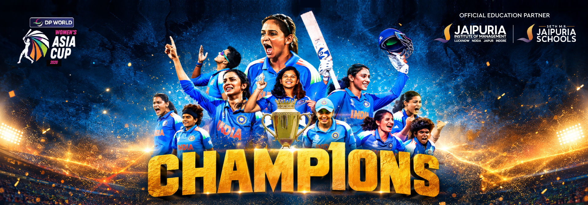 India women's cricket team celebrates victory around a gold trophy on a stadium banner reading 'CHAMPIONS' in bold gold letters with blue jerseys and bright stadium lights in the background.