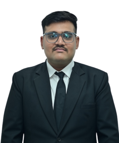 Portrait of a young man in a black suit and tie, wearing glasses, looking at the camera with a neutral expression.