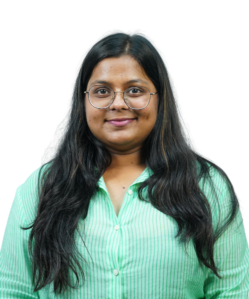 Young woman with long dark hair and round glasses, wearing a light green striped button-down shirt, facing the camera.