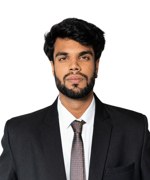 Professional head-and-shoulders portrait of a man with dark hair and beard, wearing a black suit and brown tie, looking at the camera.