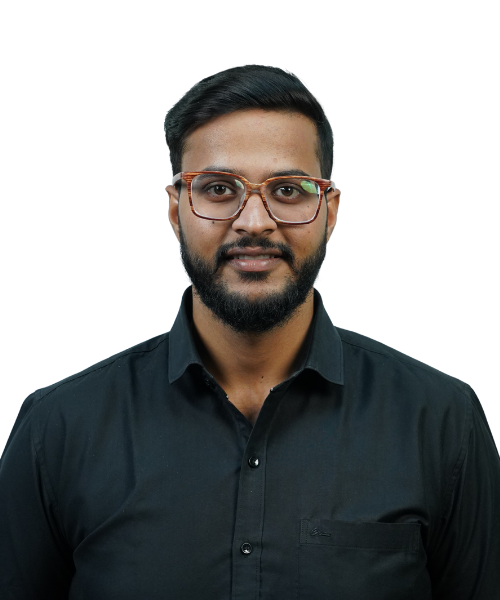 Portrait of a man with a beard and rectangular glasses wearing a black button-down shirt, facing the camera.