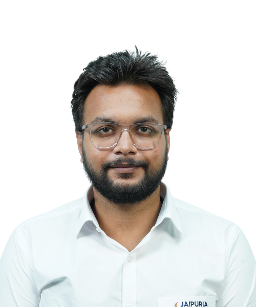 Portrait of a man with glasses and a beard, wearing a white button-down shirt, looking at the camera.
