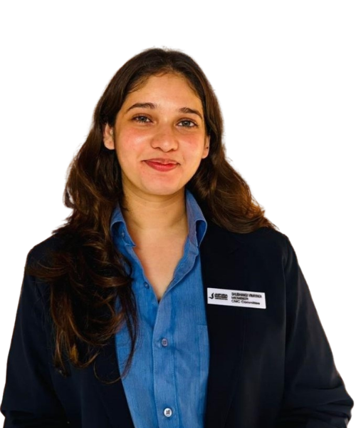 Portrait of a young woman with long brown hair, wearing a blue shirt and navy blazer with a name badge, smiling at the camera.]